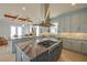 Well-appointed kitchen with a gas cooktop, granite countertops, and a view of the living room with a fireplace at 1221 Commodore Dr, New Smyrna Beach, FL 32168