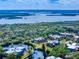 Stunning aerial view of the community, featuring waterfront access, lush landscaping, and inviting rooftops at 133 Cedar Dunes Dr, New Smyrna Beach, FL 32169