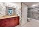 Well-lit bathroom with floral wallpaper, granite vanity, and walk-in shower featuring gray marble-look surround at 133 Cedar Dunes Dr, New Smyrna Beach, FL 32169