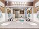 Bathroom featuring double sinks, granite counters, and decorative lighting at 133 Cedar Dunes Dr, New Smyrna Beach, FL 32169