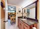 Bathroom featuring a granite countertop and a doorway leading to the dining room at 133 Cedar Dunes Dr, New Smyrna Beach, FL 32169
