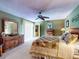 Comfortable bedroom with wood furnishings, ceiling fan, and sliding door access to outdoor space at 133 Cedar Dunes Dr, New Smyrna Beach, FL 32169