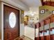 Inviting entryway with decorative glass door, tiled floor, and a staircase leading to the upper level at 133 Cedar Dunes Dr, New Smyrna Beach, FL 32169