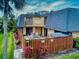 Charming home featuring a private patio with outdoor seating and colorful landscaping at 133 Cedar Dunes Dr, New Smyrna Beach, FL 32169