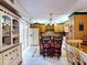 Charming kitchen view with a central island, wood cabinets, tiled floors and access to the outside at 133 Cedar Dunes Dr, New Smyrna Beach, FL 32169