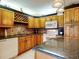 Traditional kitchen features granite counters, wood cabinetry, wine rack and a stylish backsplash at 133 Cedar Dunes Dr, New Smyrna Beach, FL 32169