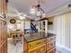 This kitchen features a center island with granite countertop and cabinetry with barstool seating for entertaining at 133 Cedar Dunes Dr, New Smyrna Beach, FL 32169