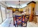 Well-lit kitchen with central island, wood cabinets, and bar seating is perfect for cooking and entertaining guests at 133 Cedar Dunes Dr, New Smyrna Beach, FL 32169