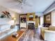 Comfortable living room featuring a fireplace, stylish wallpaper, and hardwood floors for a relaxing ambiance at 133 Cedar Dunes Dr, New Smyrna Beach, FL 32169