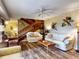 Charming living room boasts hardwood floors, tropical wallpaper, and access to the staircase at 133 Cedar Dunes Dr, New Smyrna Beach, FL 32169