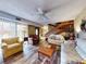 Spacious living room with hardwood floors, staircase, and ample seating, great for entertaining and relaxation at 133 Cedar Dunes Dr, New Smyrna Beach, FL 32169