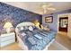 Bedroom featuring a queen bed, ceiling fan, night stands and lamps, and a quaint sitting chair at 133 Cedar Dunes Dr, New Smyrna Beach, FL 32169