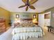 Green main bedroom features a ceiling fan, a king bed with nightstands, and ensuite bathroom at 133 Cedar Dunes Dr, New Smyrna Beach, FL 32169