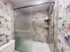 Tiled walk-in shower stall with sliding glass doors and integrated shelving at 133 Cedar Dunes Dr, New Smyrna Beach, FL 32169