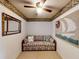 Cozy sitting room with striped couch, ceiling fan, nautical decor, and neutral carpet at 133 Cedar Dunes Dr, New Smyrna Beach, FL 32169