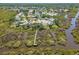 Serene aerial view showcasing the community's lake, homes, and nature preserve boardwalk at 1363 Wayne Ave, New Smyrna Beach, FL 32168