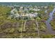 Overhead view of a property highlighting its serene waterfront location and private dock amidst a neighborhood at 1363 Wayne Ave, New Smyrna Beach, FL 32168