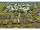 Neighborhood aerial view showing the lake with the preserve boardwalk and surrounding houses at 1363 Wayne Ave, New Smyrna Beach, FL 32168
