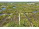 Serene aerial view of a dock stretching into marsh, offering peaceful waterfront living at 1363 Wayne Ave, New Smyrna Beach, FL 32168