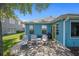 Turquoise house featuring brick patio set with outdoor furniture in landscaped backyard at 1363 Wayne Ave, New Smyrna Beach, FL 32168