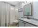 Bathroom with a vanity, an undermount sink, decorative mirror and a shower-tub combination at 1363 Wayne Ave, New Smyrna Beach, FL 32168