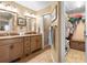 Bathroom with double vanity, tile floor, and walk-in closet at 1363 Wayne Ave, New Smyrna Beach, FL 32168