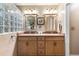 Bathroom features a double vanity with stylish mirrors and a tiled shower at 1363 Wayne Ave, New Smyrna Beach, FL 32168