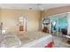 Cozy bedroom with tiled floors, a TV, and sliding glass doors to the outdoor patio at 1363 Wayne Ave, New Smyrna Beach, FL 32168