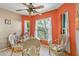 Bright breakfast nook with wicker furniture and sun-drenched windows overlooking the yard at 1363 Wayne Ave, New Smyrna Beach, FL 32168
