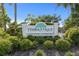 Entrance to Tymber Trace, a covenant restricted community with lush landscaping and mature trees at 1363 Wayne Ave, New Smyrna Beach, FL 32168