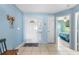 Welcoming entryway boasts a tile floor, decorative front door, and flows to the bedroom hallway at 1363 Wayne Ave, New Smyrna Beach, FL 32168