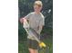 Young boy holding a large fish with a proud smile, highlighting the local fishing opportunities at 1363 Wayne Ave, New Smyrna Beach, FL 32168