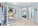 Inviting foyer with tiled floor, glass adorned door, and views to the living spaces in this coastal residence at 1363 Wayne Ave, New Smyrna Beach, FL 32168
