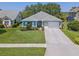 Charming one-story home with well-manicured lawn, mature landscaping and light blue exterior at 1363 Wayne Ave, New Smyrna Beach, FL 32168