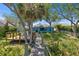 Inviting blue home featuring a path to the dock and well-manicured lawn at 1363 Wayne Ave, New Smyrna Beach, FL 32168