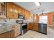 Well-appointed kitchen featuring granite countertops, wood cabinets, and stainless steel appliances at 1363 Wayne Ave, New Smyrna Beach, FL 32168