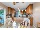 Open concept kitchen with granite countertops, wooden cabinets and bar stool seating at 1363 Wayne Ave, New Smyrna Beach, FL 32168