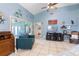Bright living room featuring tile flooring, coastal decor, and sliders leading to the lanai at 1363 Wayne Ave, New Smyrna Beach, FL 32168