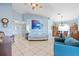Open living room with a tile floor, and a seamless flow to the dining area creating a spacious living space at 1363 Wayne Ave, New Smyrna Beach, FL 32168