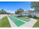 Community shuffleboard court next to a cozy cabana, with a clear blue sky above at 1363 Wayne Ave, New Smyrna Beach, FL 32168