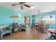 Sunroom featuring colorful decor, multiple seating areas, and views of the outdoors at 1363 Wayne Ave, New Smyrna Beach, FL 32168