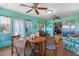 Enclosed sunroom with ceiling fans and views of the backyard at 1363 Wayne Ave, New Smyrna Beach, FL 32168