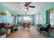 Enclosed sunroom boasting multiple seating areas, ceiling fans, and access to the outdoors at 1363 Wayne Ave, New Smyrna Beach, FL 32168