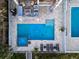 Aerial view of the backyard, showcasing the pool, spa, patio, and outdoor seating areas at 1373 N Atlantic Ave, New Smyrna Beach, FL 32169