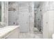 Luxurious bathroom featuring marble tiling, a glass-enclosed shower, and elegant fixtures for a spa-like experience at 1373 N Atlantic Ave, New Smyrna Beach, FL 32169