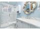 Modern bathroom with beautiful vanity and a glass door shower with mosaic tile at 1373 N Atlantic Ave, New Smyrna Beach, FL 32169