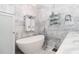 Luxurious bathroom with a freestanding tub, elegant fixtures, and marble wall and floor tiles at 1373 N Atlantic Ave, New Smyrna Beach, FL 32169