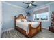 Charming bedroom with a decorative wood frame bed, blue walls, and decorative accents at 1373 N Atlantic Ave, New Smyrna Beach, FL 32169