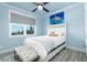 Comfortable bedroom featuring a turtle artwork, accent rug and ceiling fan at 1373 N Atlantic Ave, New Smyrna Beach, FL 32169