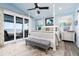 Light and airy bedroom with a four-poster bed, ocean view balcony, and blue accents at 1373 N Atlantic Ave, New Smyrna Beach, FL 32169
